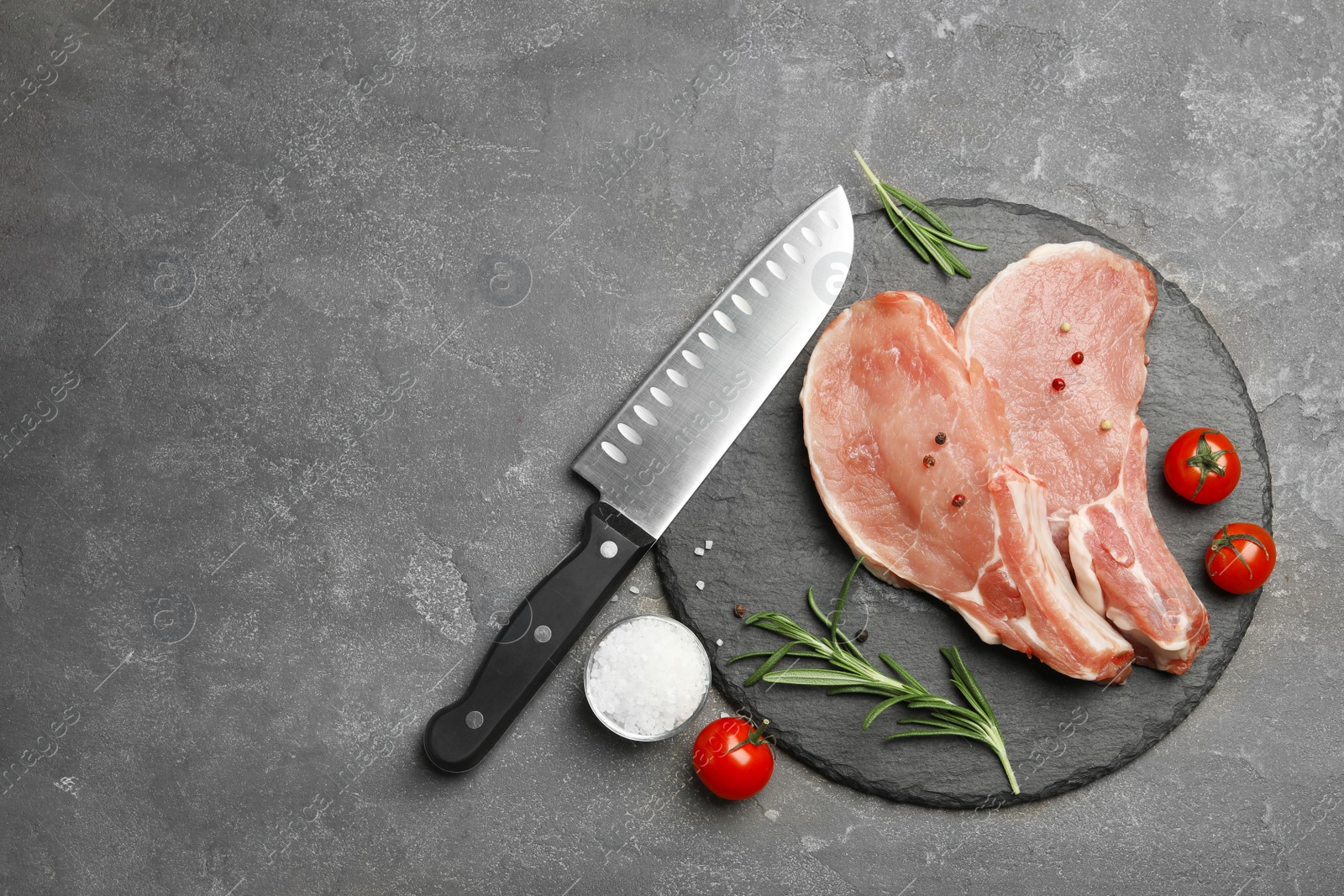 Photo of Flat lay composition with fresh raw cut meat on grey table. Space for text