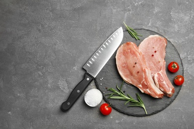 Photo of Flat lay composition with fresh raw cut meat on grey table. Space for text