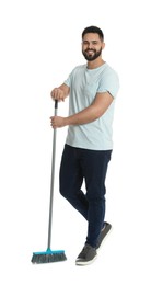 Young man with broom on white background