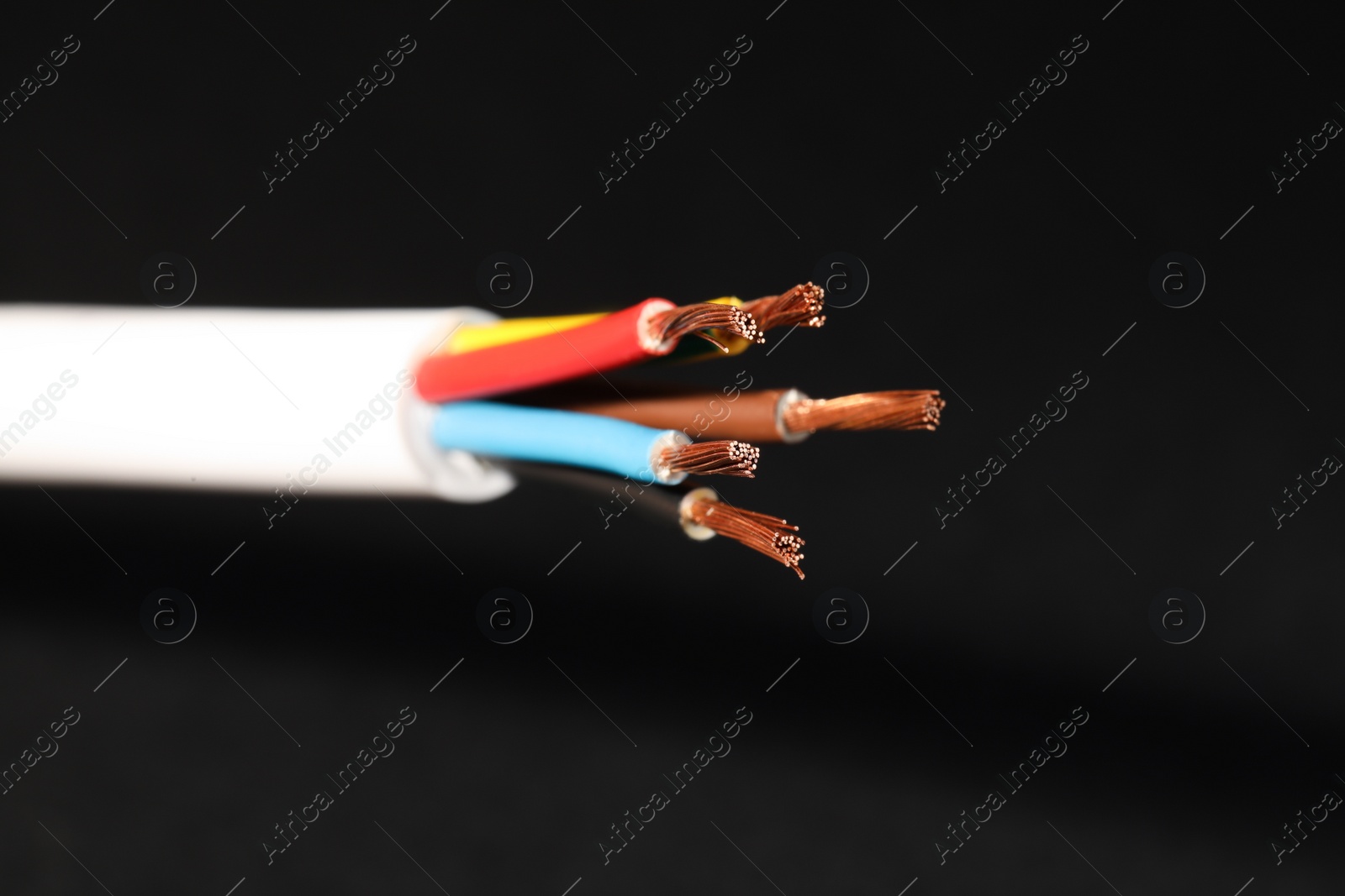 Photo of Electrical wires on black background, closeup view