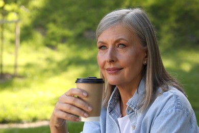 Photo of Portrait of beautiful senior woman with paper cup of coffee outdoors