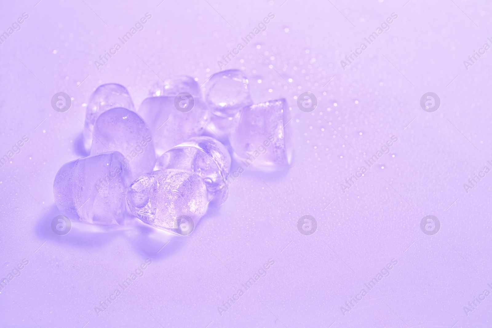 Photo of Ice cubes on color background. Space for text