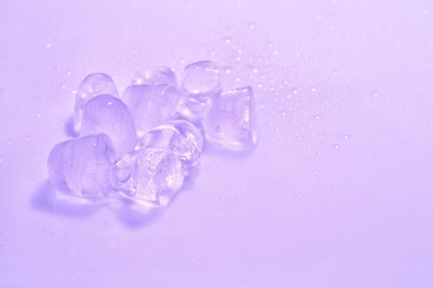 Ice cubes on color background. Space for text