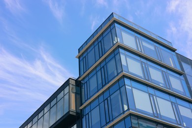 Low angle view of modern buildings against blue sky