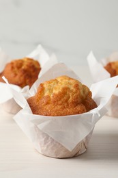 Tasty muffins on white wooden table, closeup. Fresh pastry