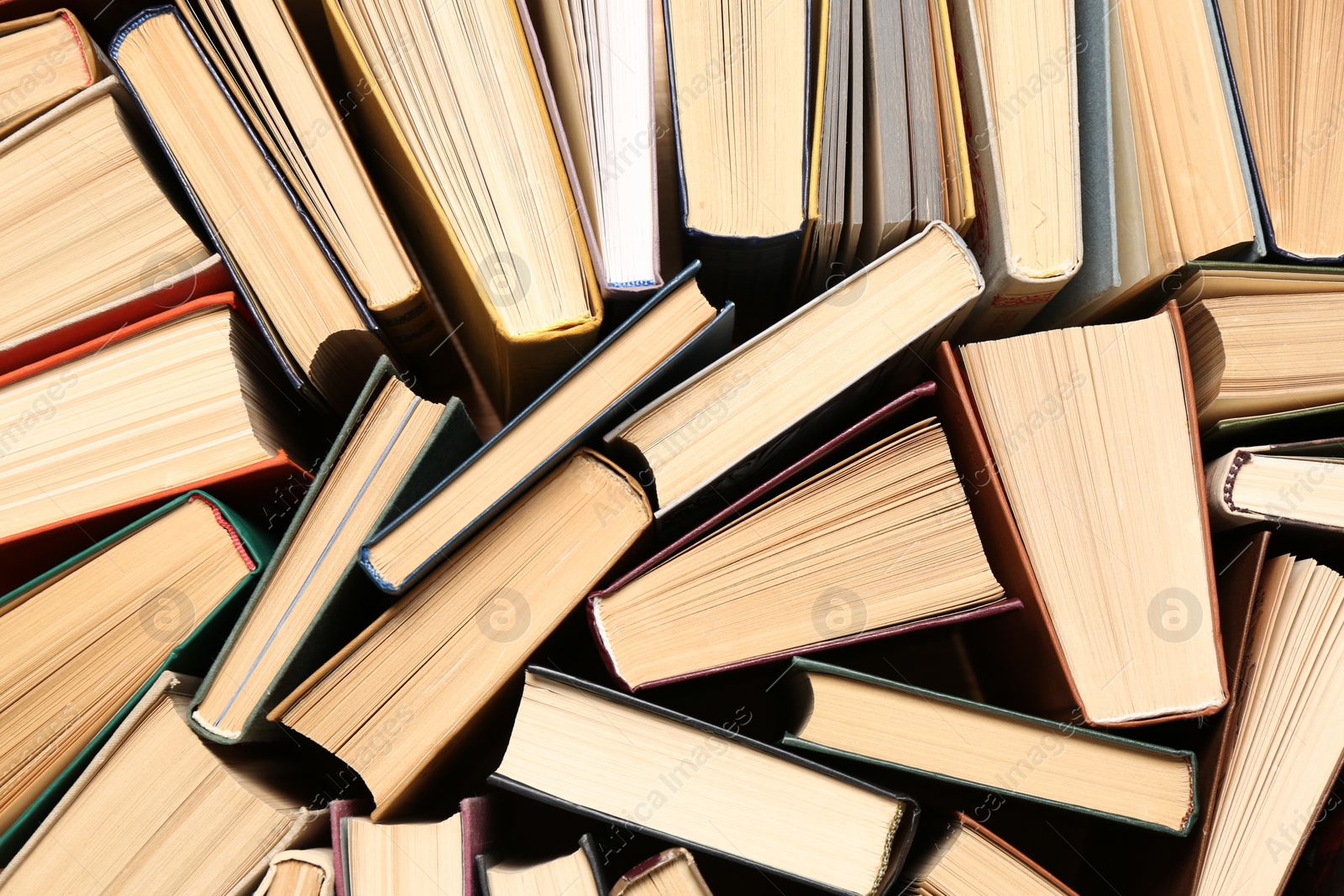 Photo of Many hardcover books as background, top view. Library material