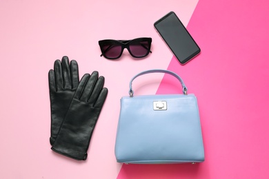 Flat lay composition with stylish black leather gloves and accessories on color background