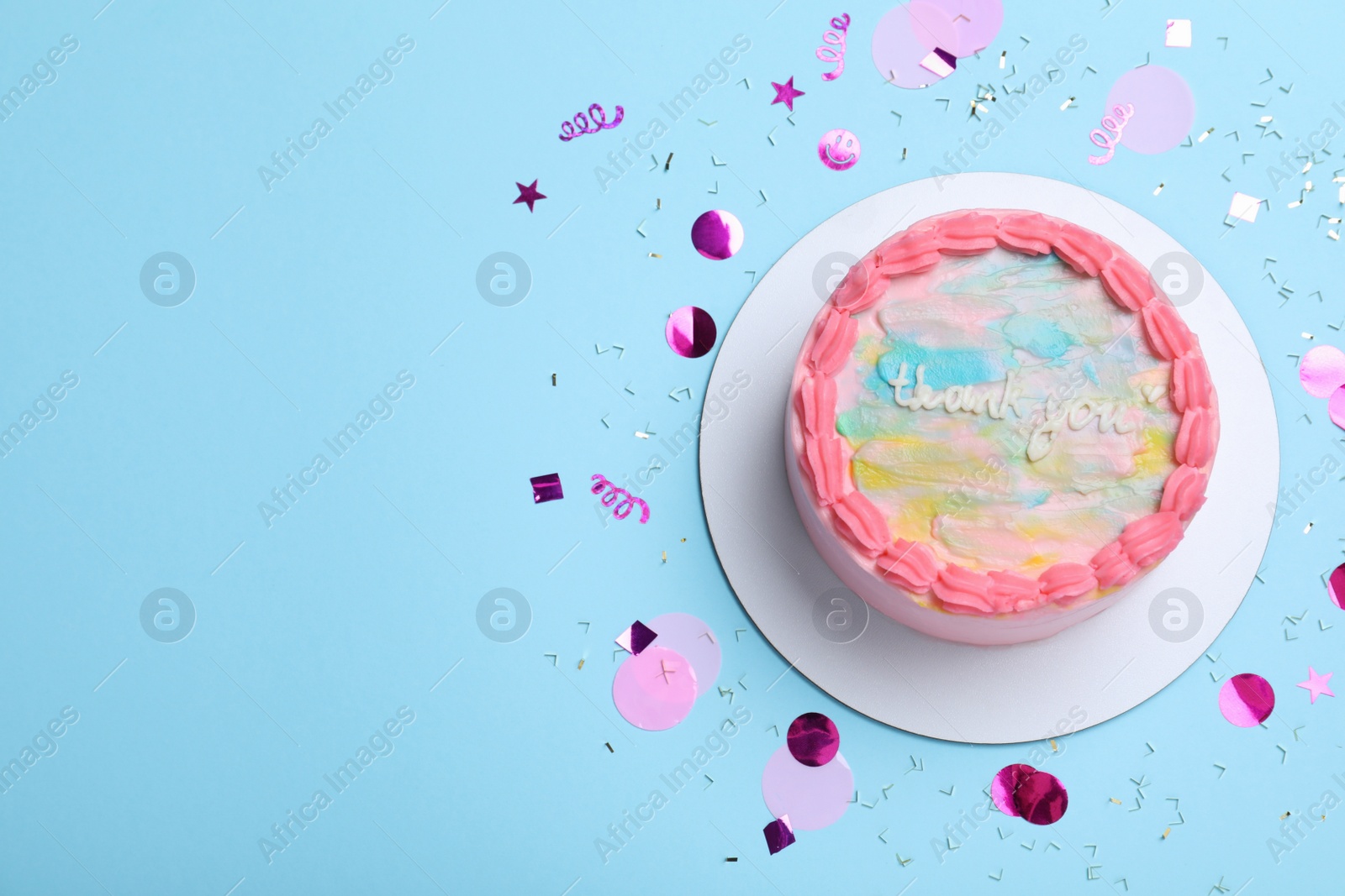 Photo of Cute bento cake with tasty cream and confetti on light blue background, flat lay. Space for text