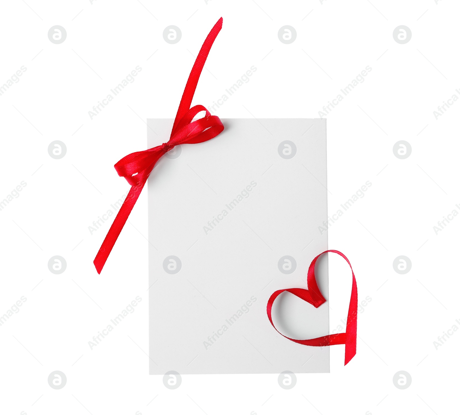 Photo of Blank card with bow and heart made of red ribbon on white background, top view. Valentine's Day celebration