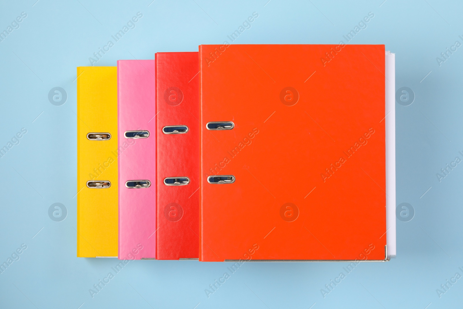 Photo of Many office folders on light blue background, flat lay