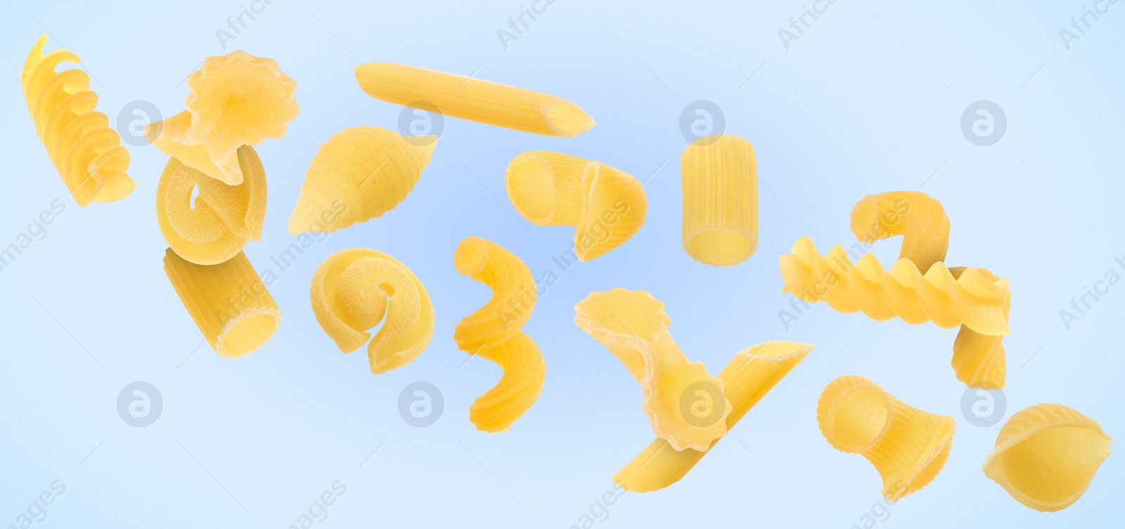 Image of Different types of pasta flying on light blue background