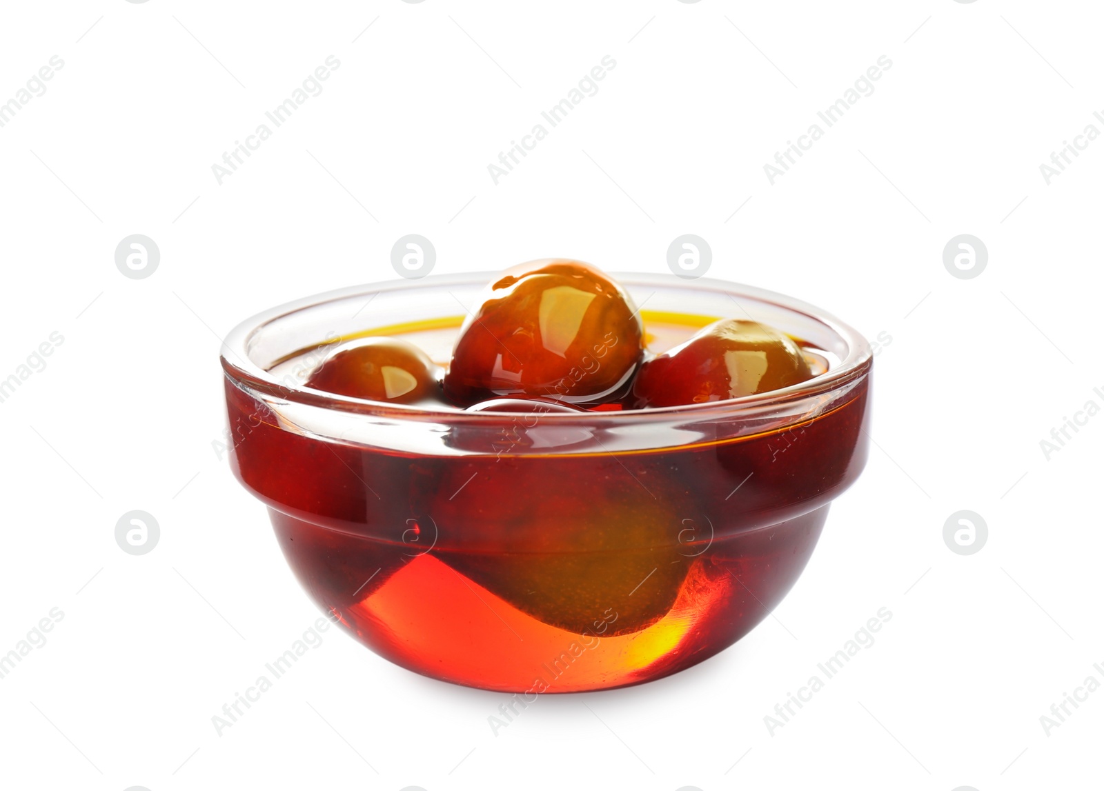 Photo of Palm oil and fruits in glass bowl isolated on white