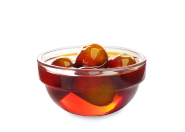 Palm oil and fruits in glass bowl isolated on white