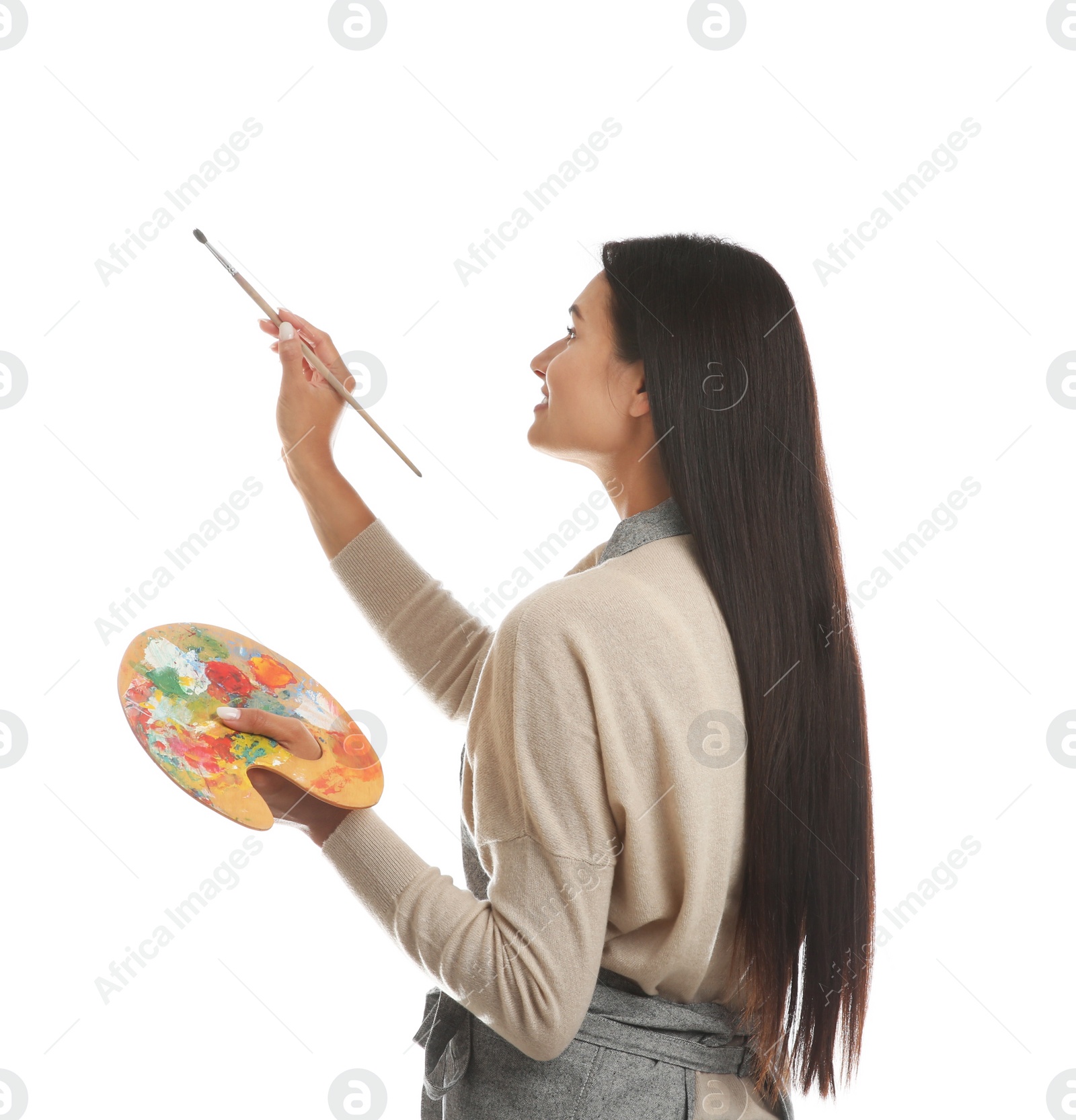 Photo of Young woman drawing with brush on white background