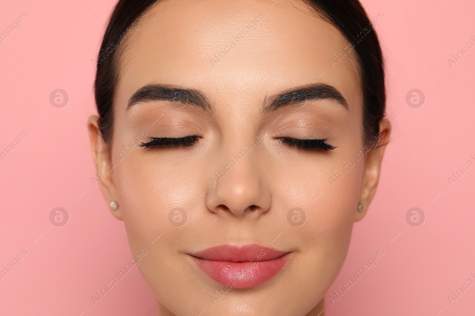 Photo of Beautiful young woman with long eyelashes on pink background, closeup