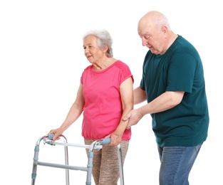 Photo of Elderly man helping his wife with walking frame on white background