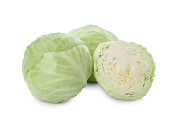 Whole and cut fresh ripe cabbages on white background