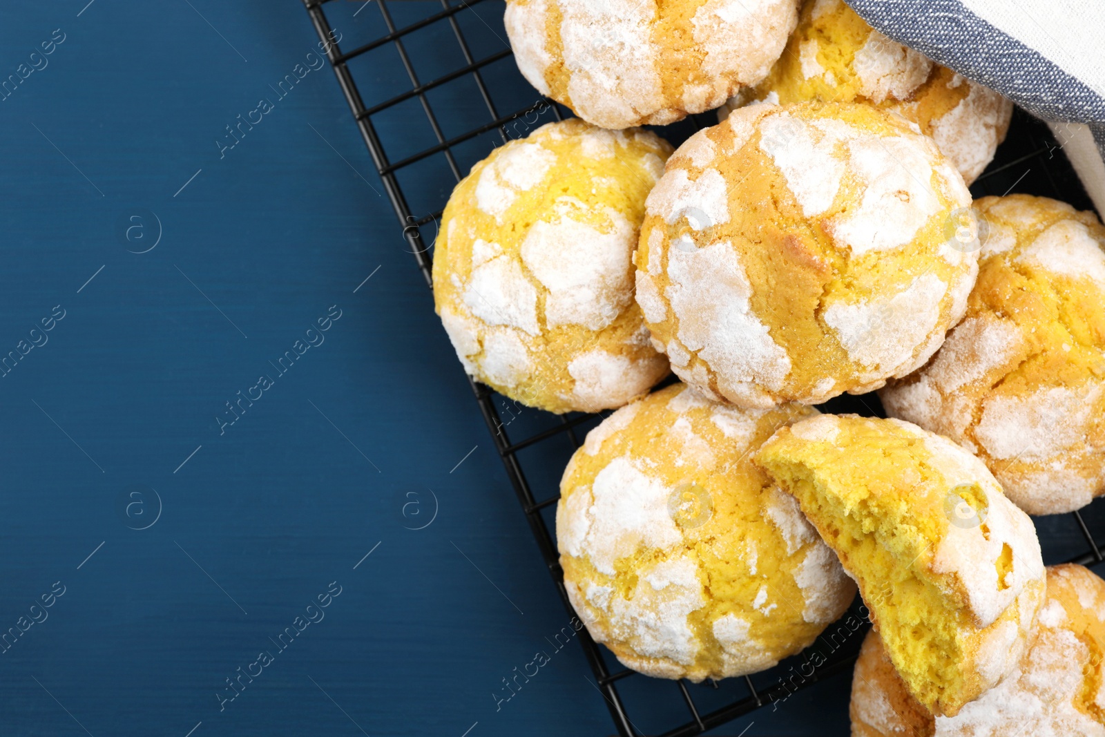 Photo of Tasty homemade lemon cookies on blue wooden table, top view. Space for text