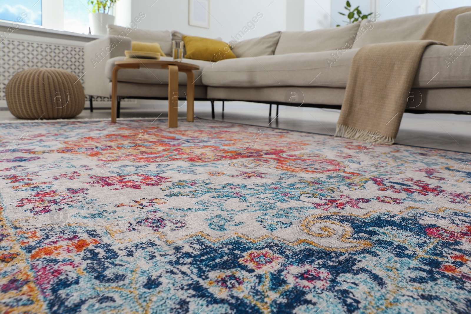 Photo of Stylish living room with beautiful carpet and furniture, low angle view. Interior design