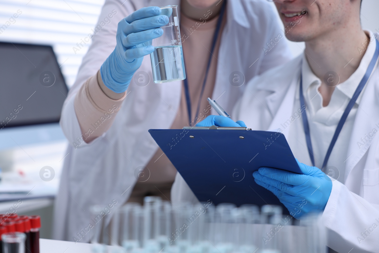 Photo of Scientists working with samples in laboratory, closeup. Medical research