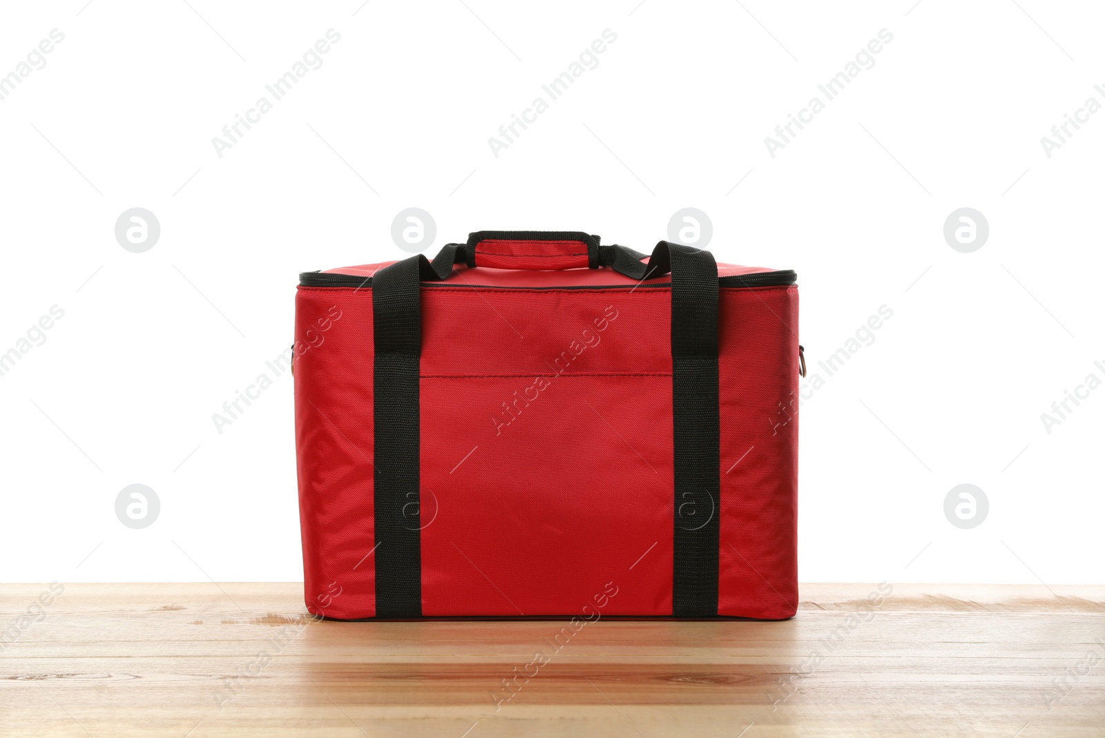 Photo of Modern red thermo bag on wooden table against white background