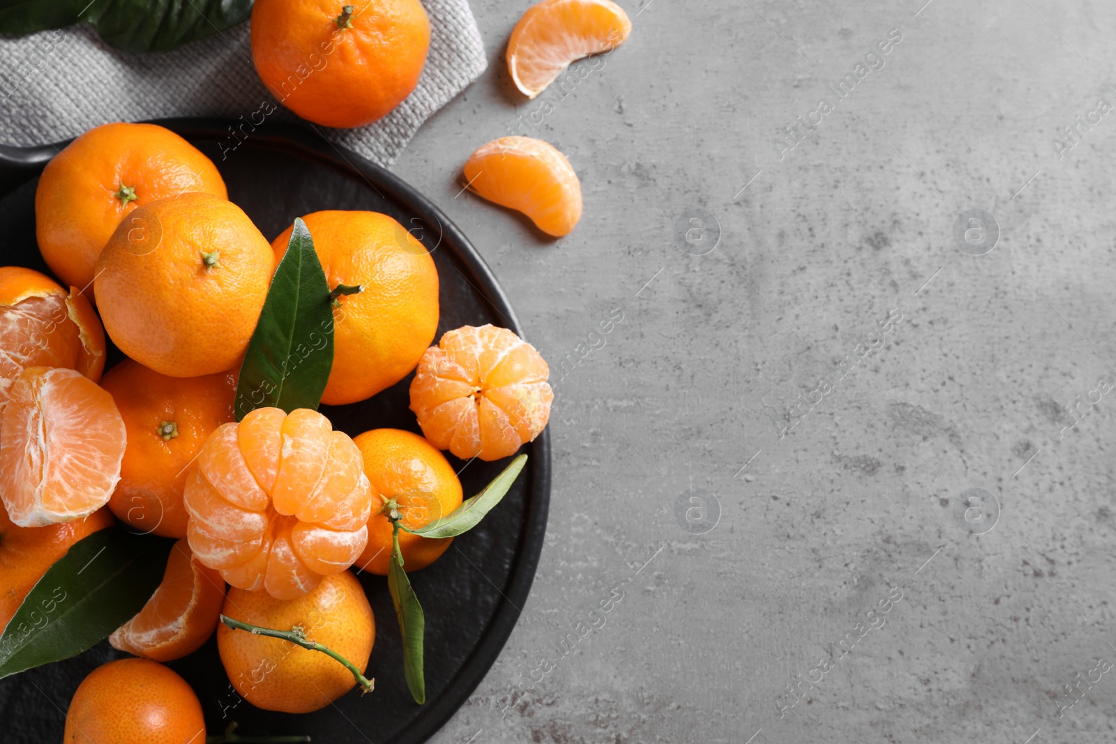 Photo of Fresh ripe tangerines on light grey table, flat lay. Space for text