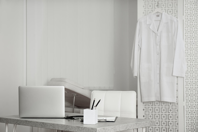 Doctor's workplace with laptop in modern clinic