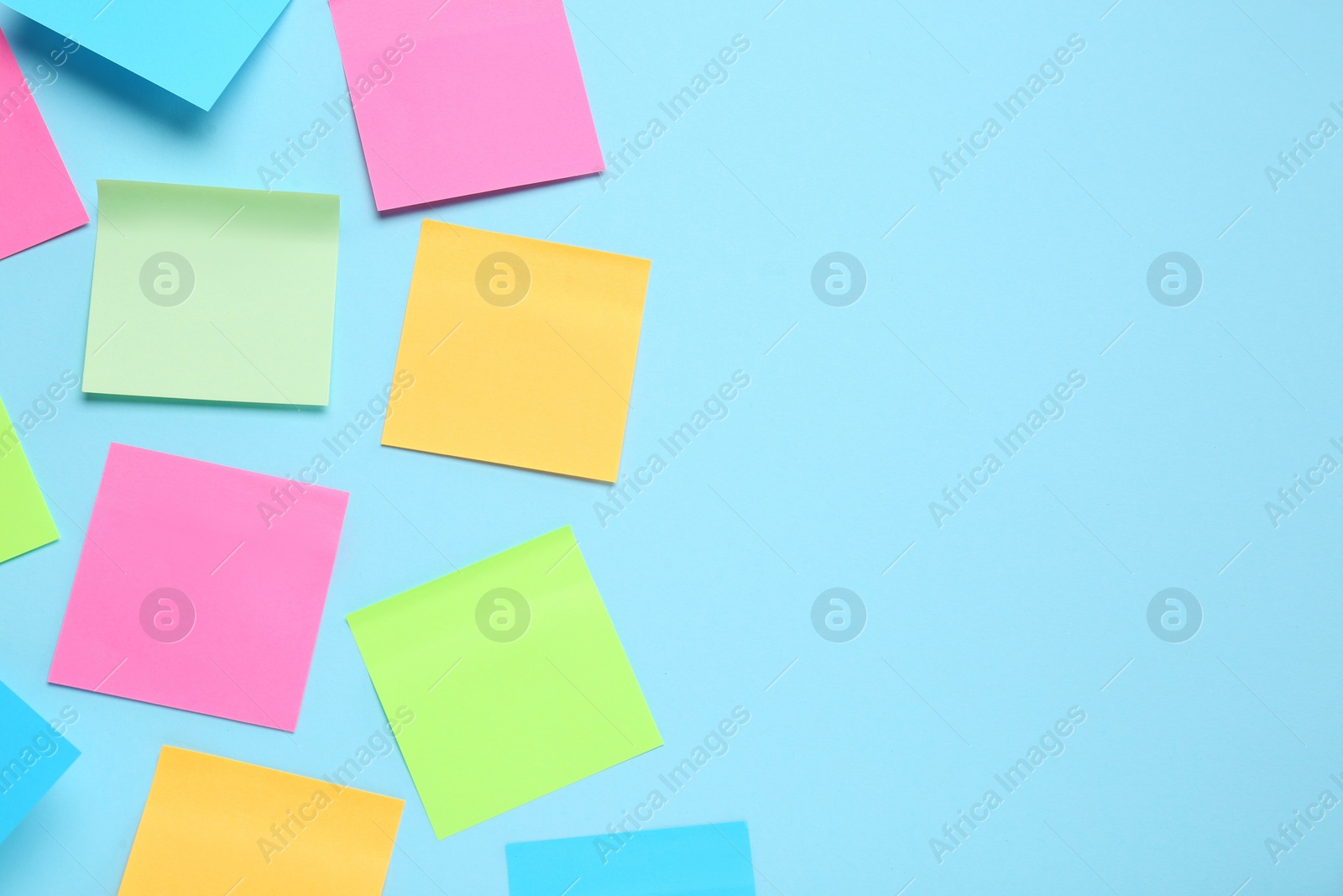 Photo of Blank colorful sticky notes on turquoise background, flat lay. Space for text