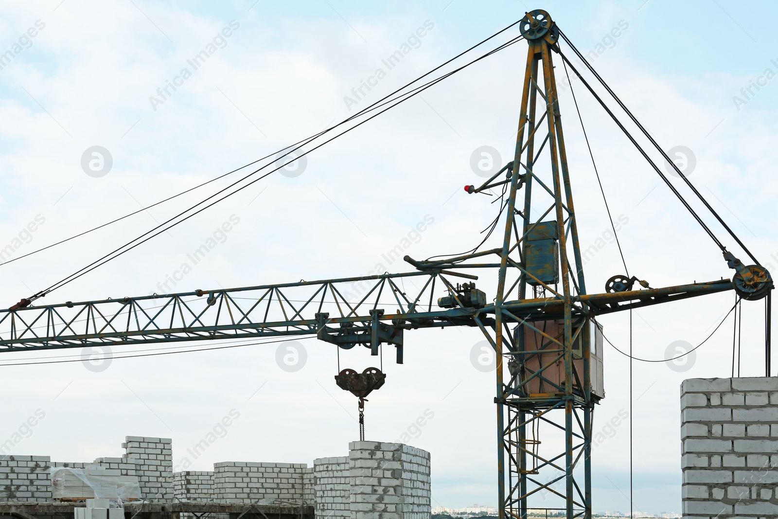 Photo of Construction site with tower crane near unfinished building