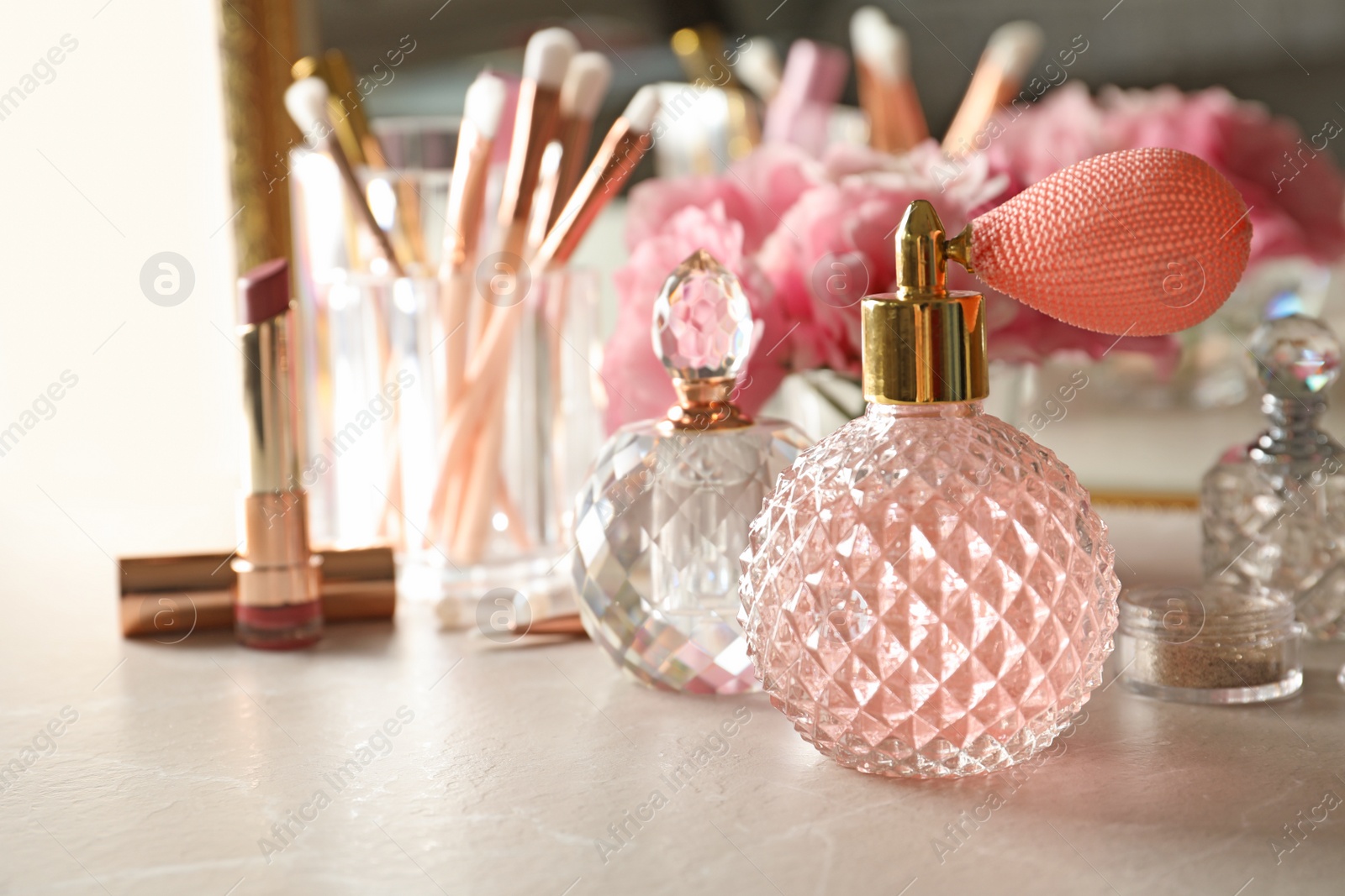 Photo of Different perfume bottles on dressing table, space for text