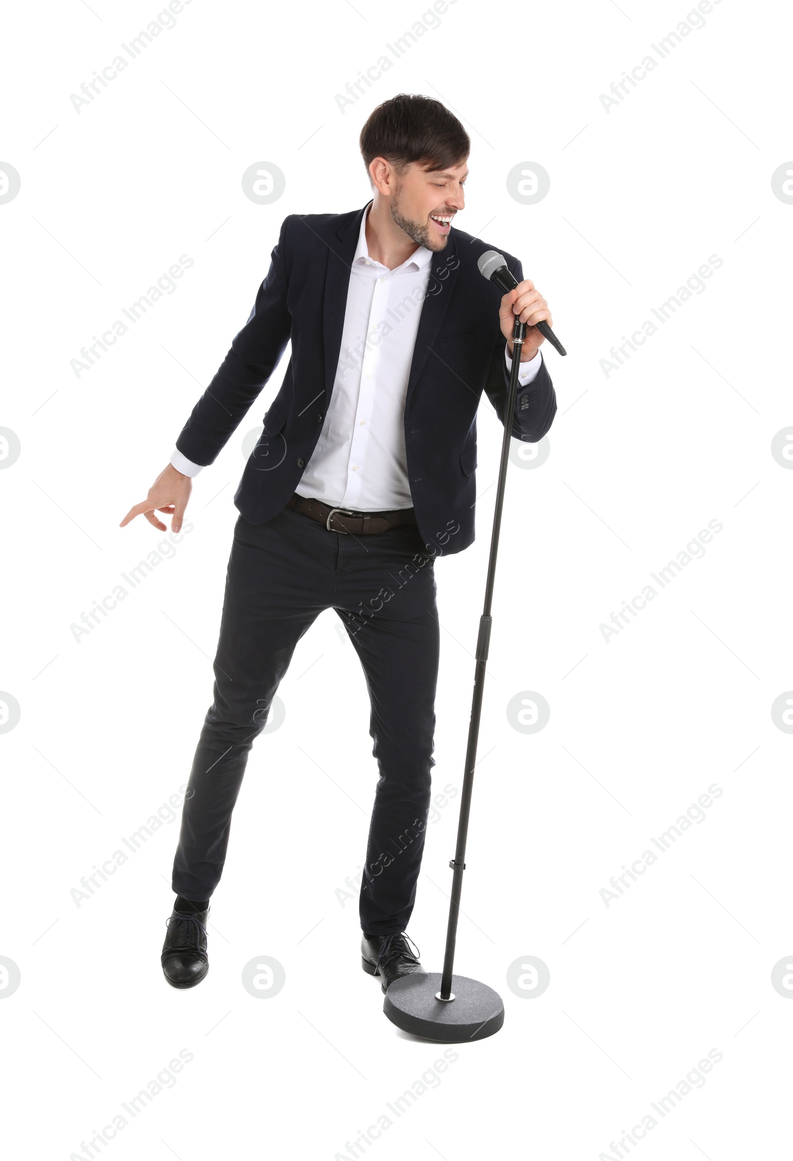 Photo of Handsome man in suit singing with microphone on white background