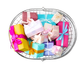 Shopping basket full of gift boxes on white background, top view