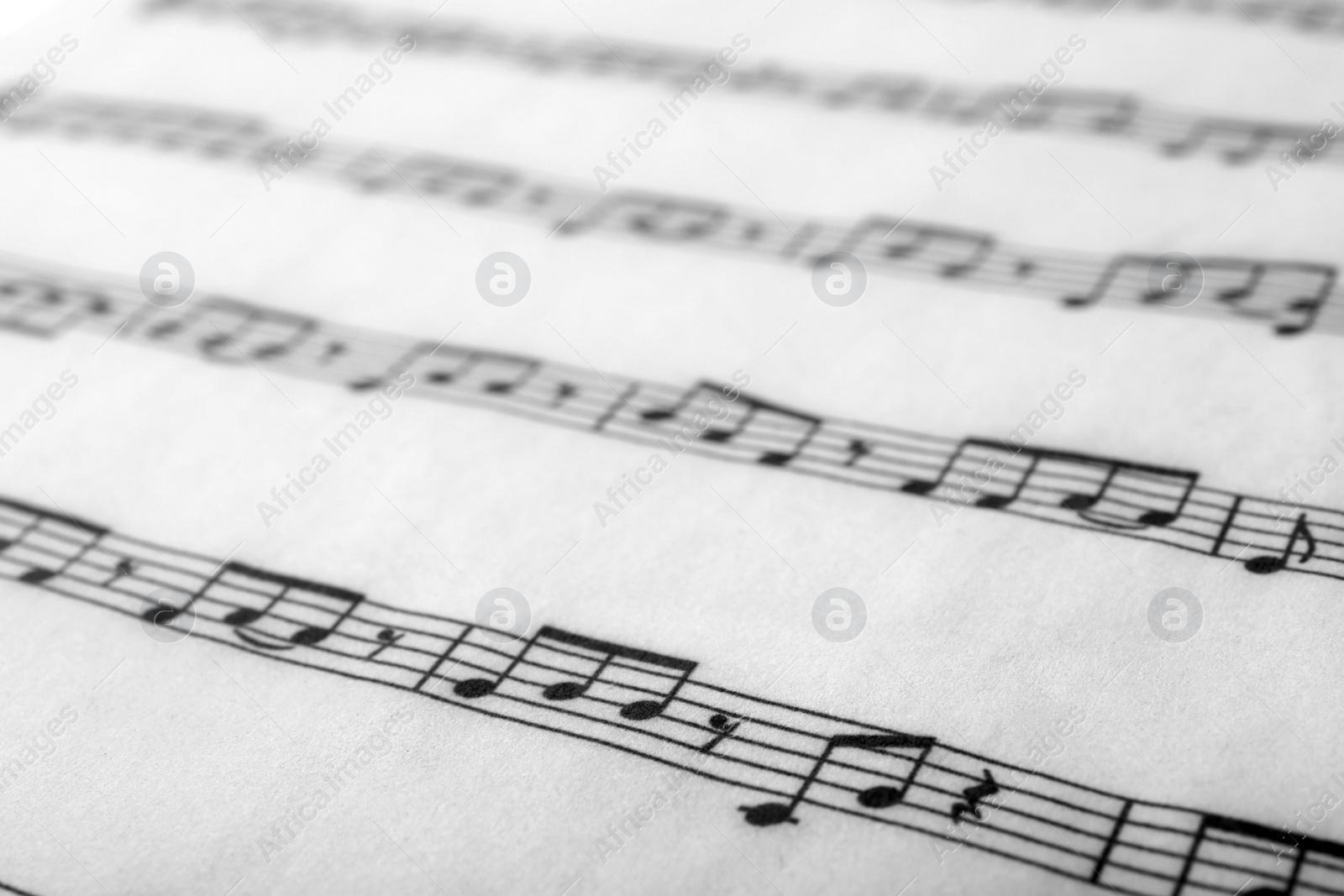 Photo of Sheet with music notes as background, closeup