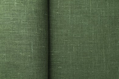 Texture of green fabric as background, top view