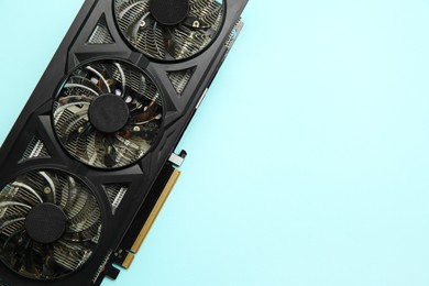 One graphics card on light blue background, top view. Space for text