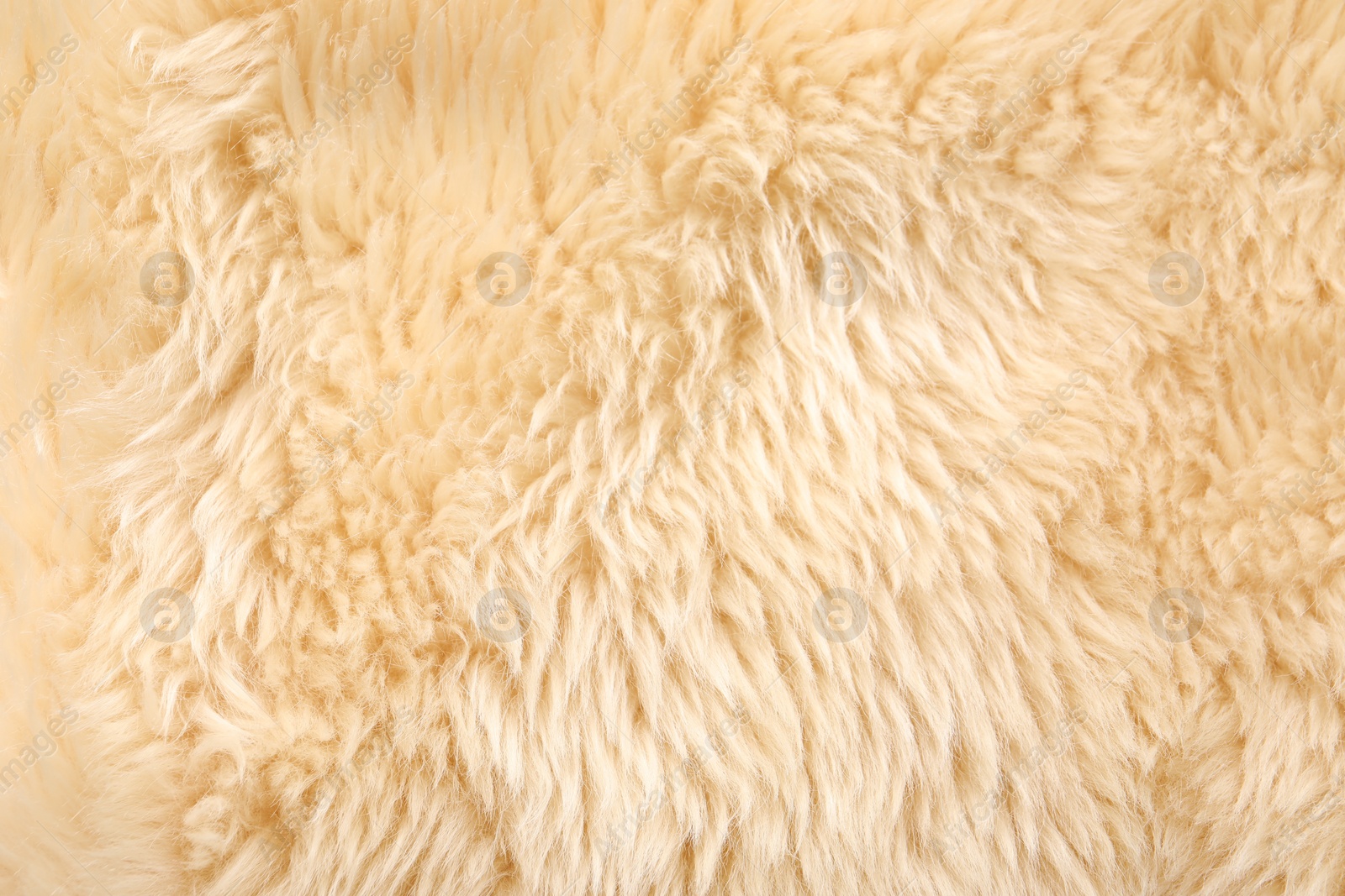 Photo of Texture of beige faux fur as background, top view