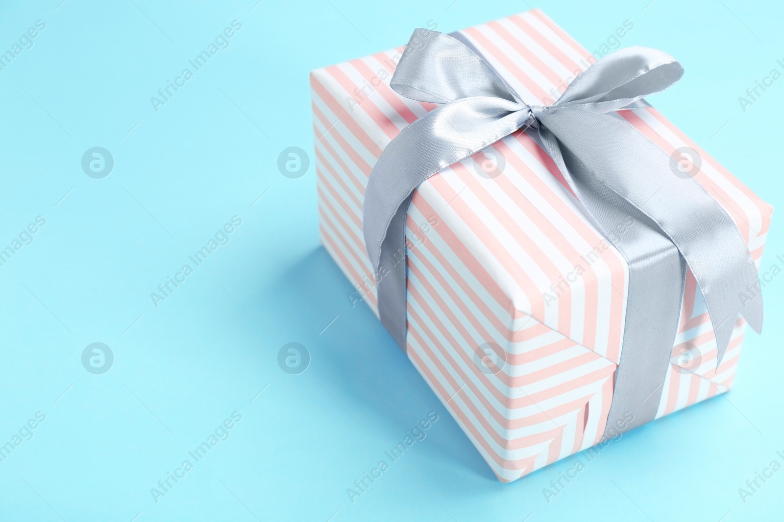 Photo of Beautifully decorated gift box on color background