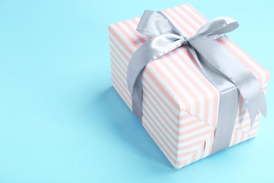 Photo of Beautifully decorated gift box on color background