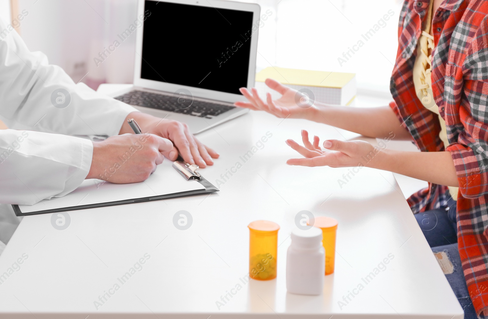 Photo of Male doctor consulting patient in clinic