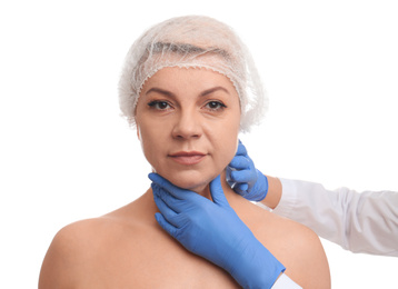 Doctor examining mature woman on white background. Double chin surgery
