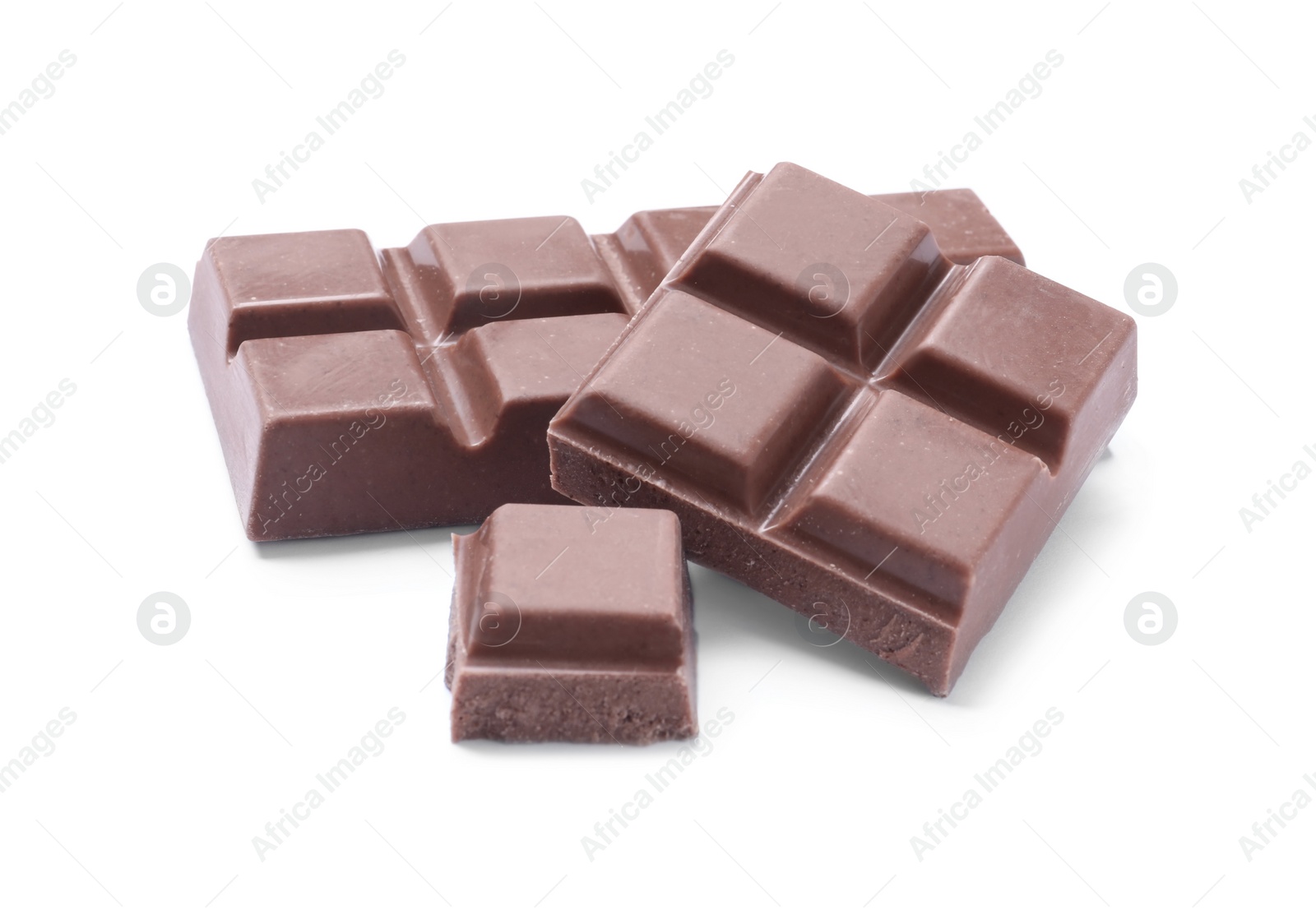 Photo of Pieces of delicious milk chocolate isolated on white