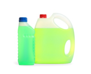 Photo of Plastic canisters with different liquids for car on white background