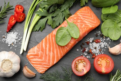 Photo of Fresh salmon and ingredients for marinade on black table, flat lay