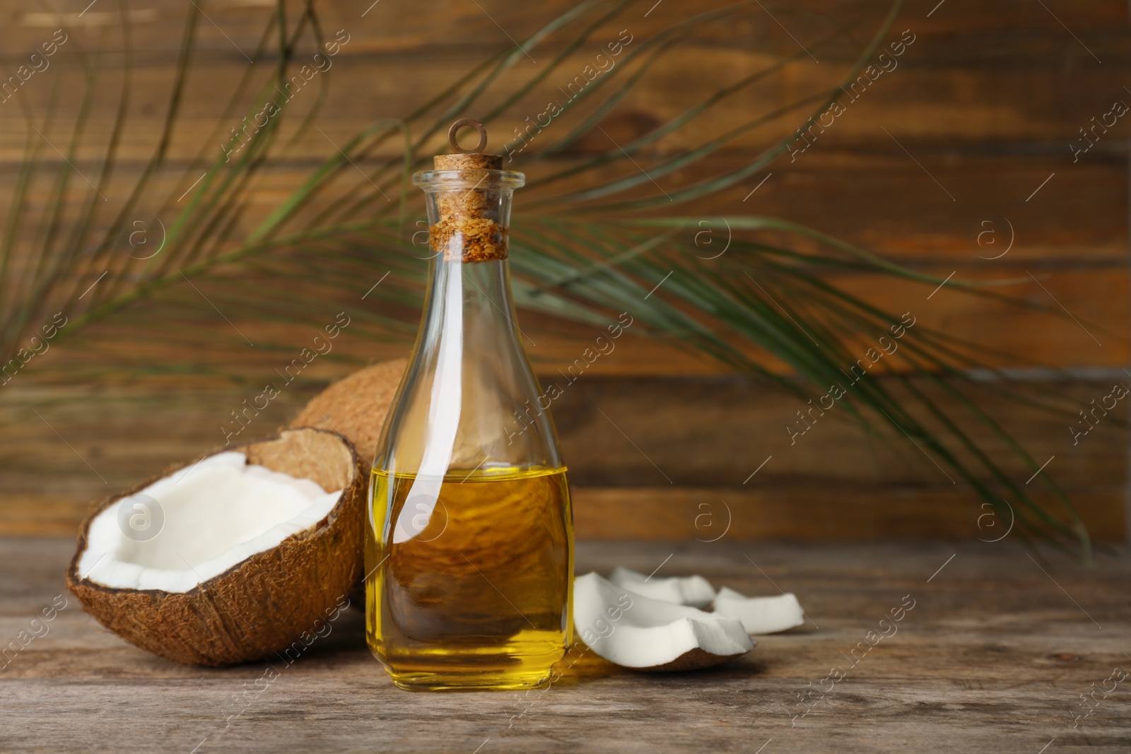 Photo of Composition with coconut oil on wooden table. Healthy cooking