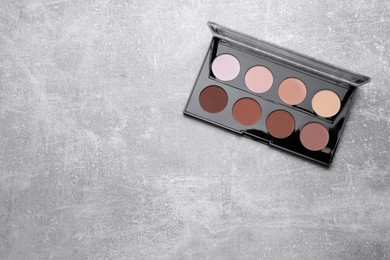 Contouring palette on light gray background, top view with space for text. Professional cosmetic product