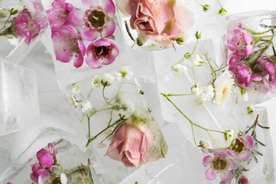 Photo of Many floral ice cubes as background, top view