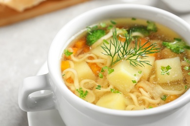 Photo of Dish of fresh homemade vegetable soup on table, closeup