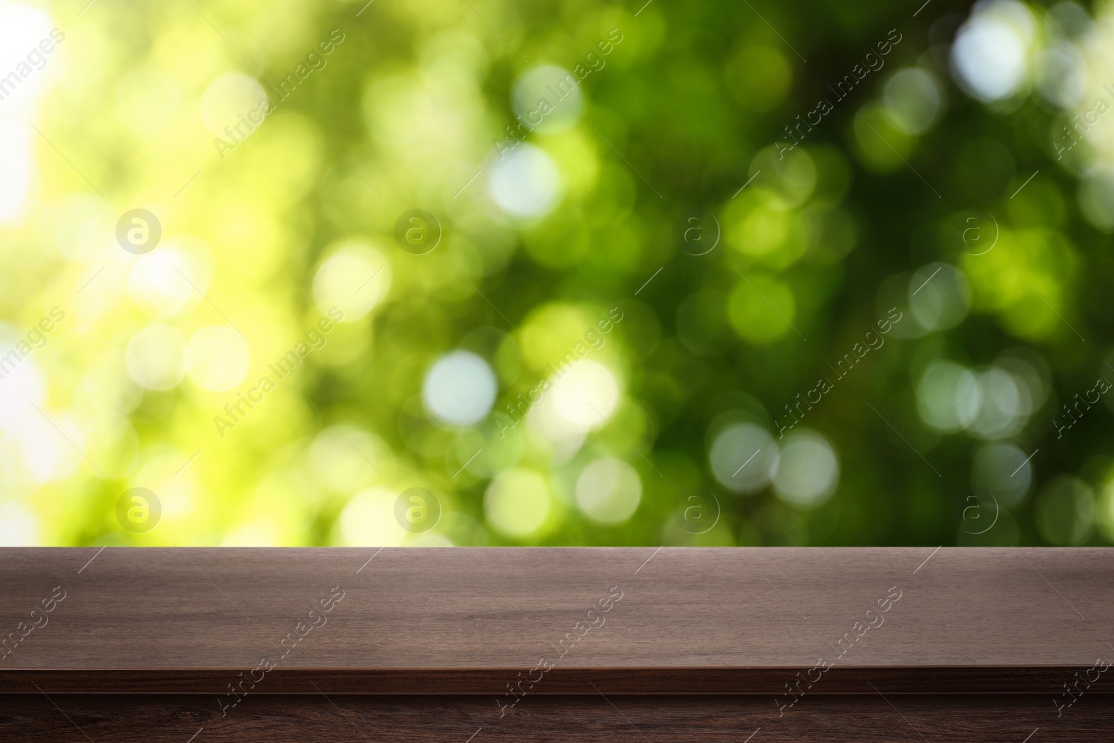 Image of Empty wooden surface against blurred green background. Space for design