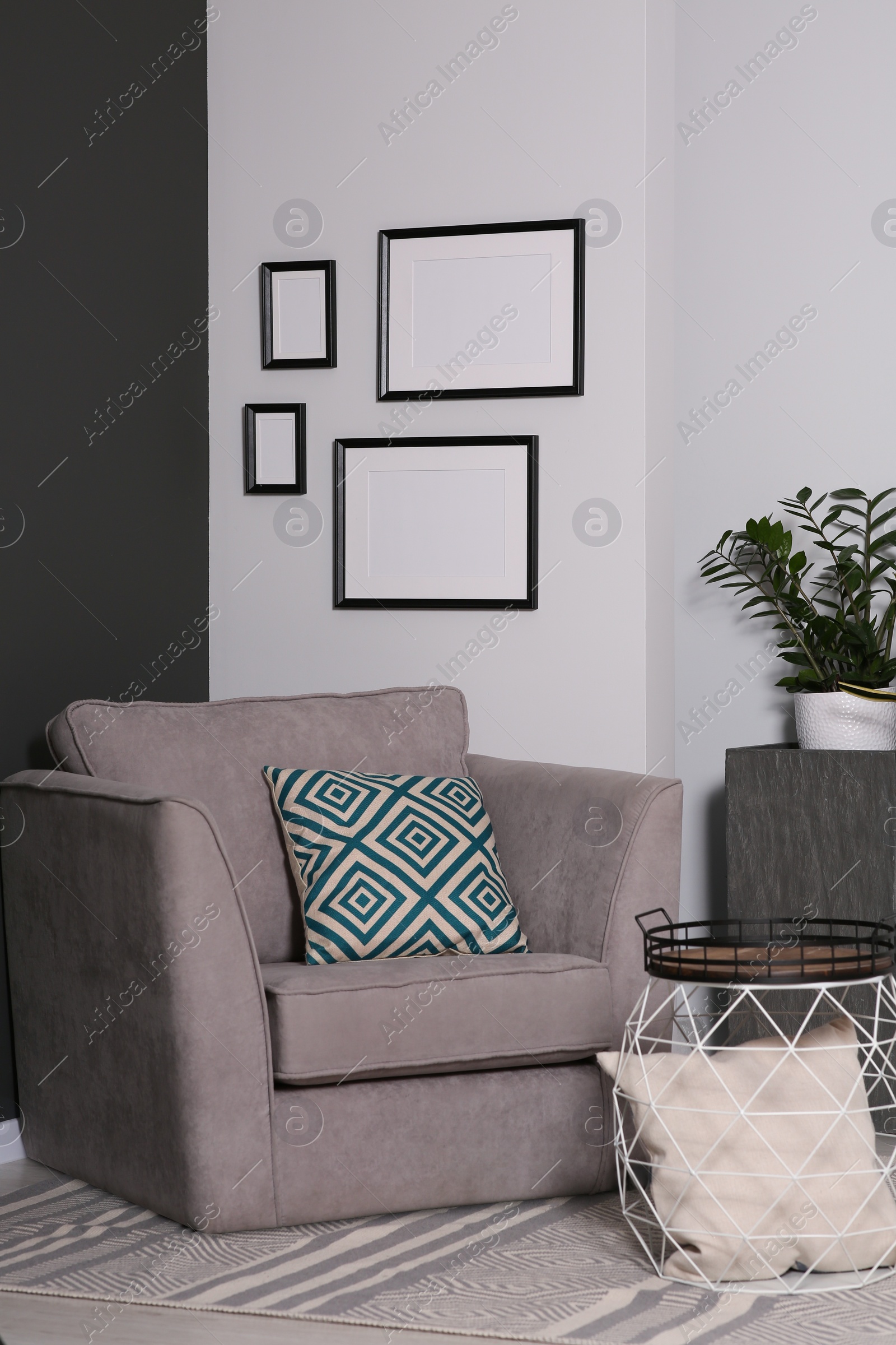 Photo of Empty frames hanging on white wall in stylish room