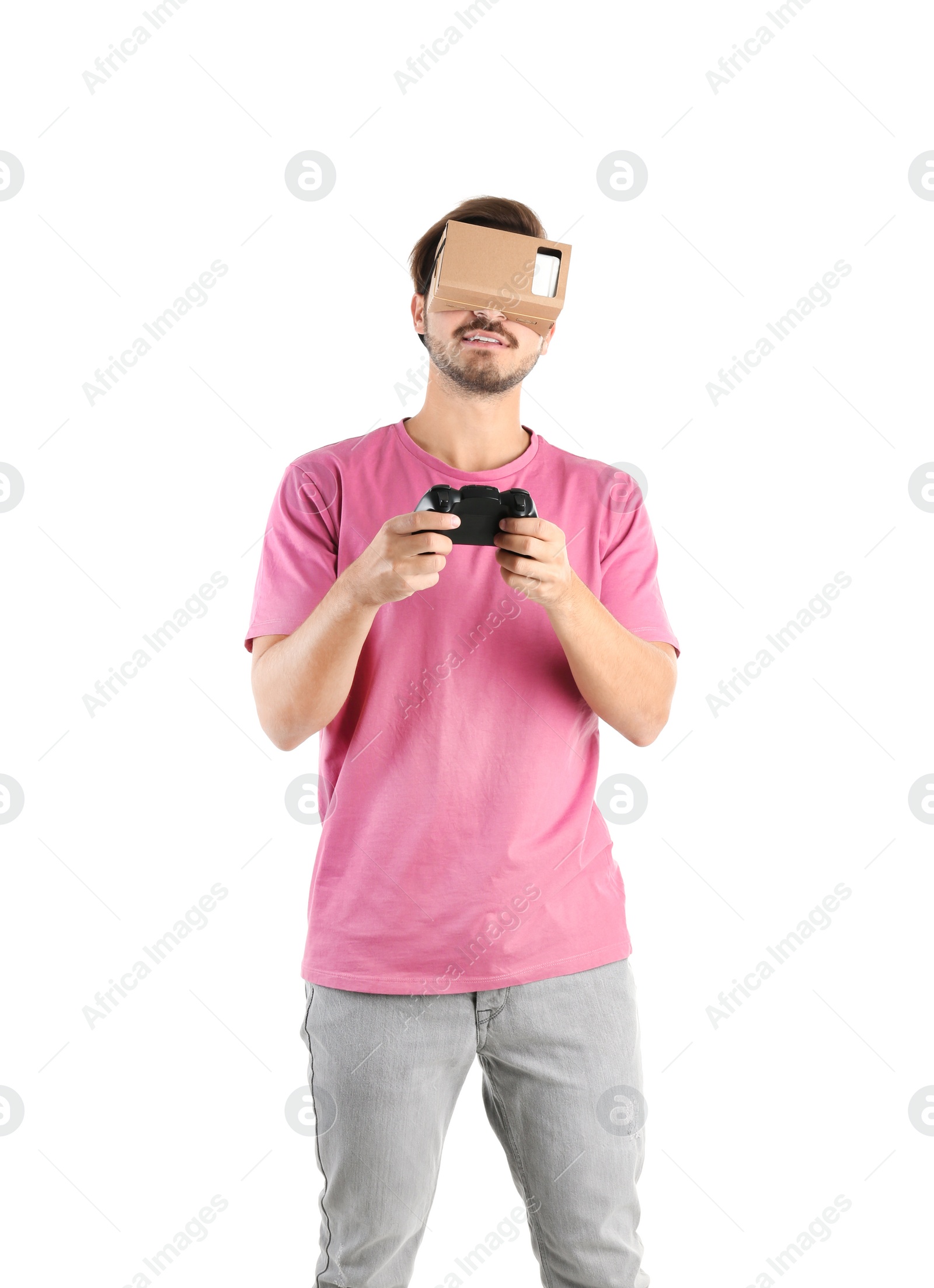 Photo of Young man using cardboard virtual reality headset, isolated on white